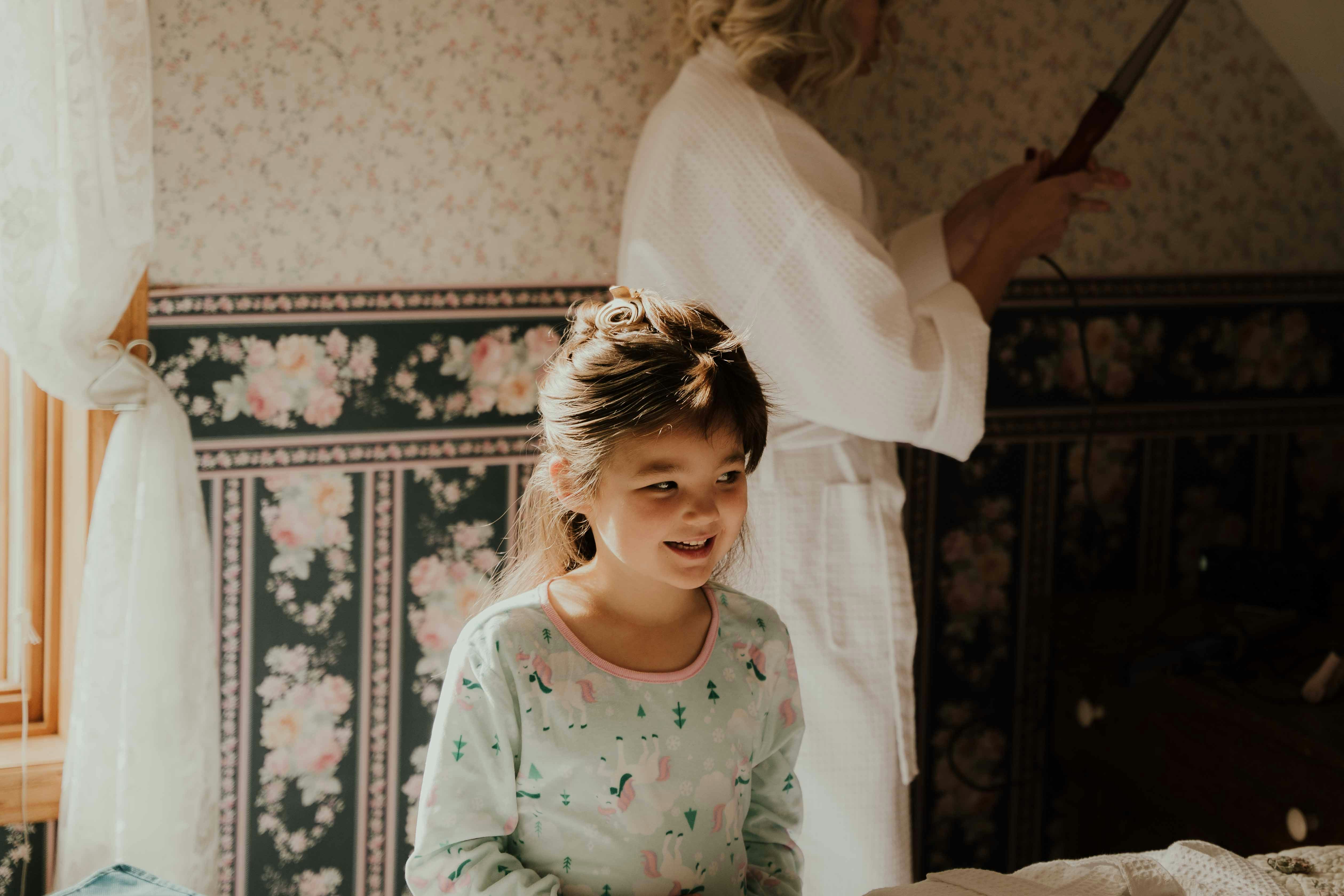 a little girl standing in a room