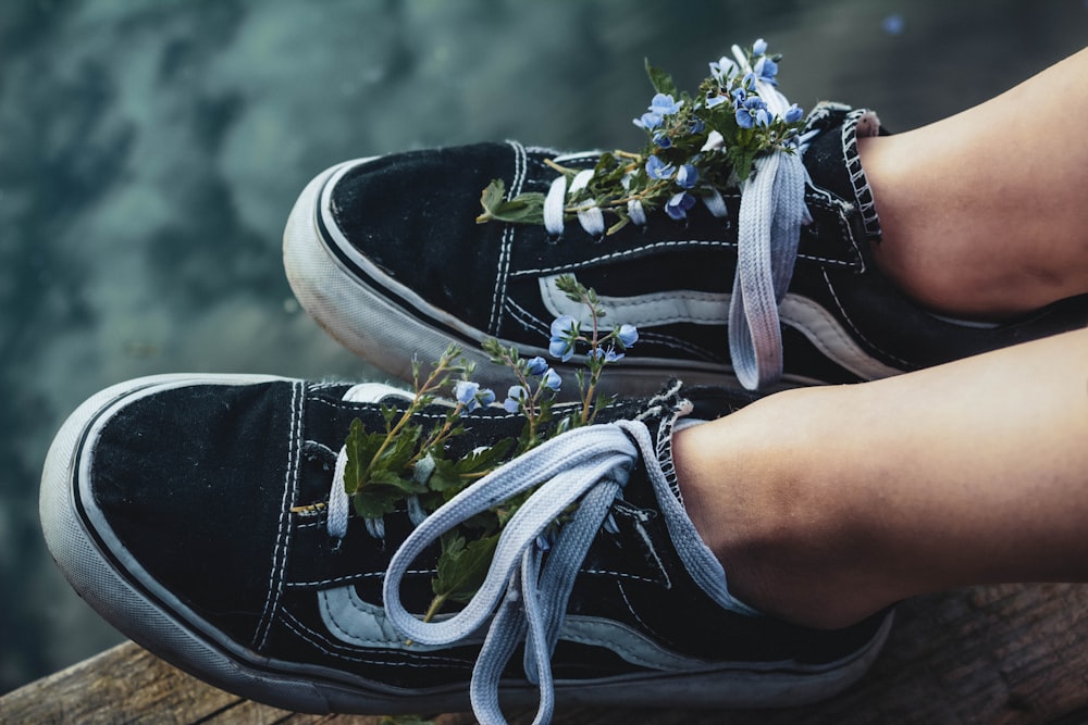 a person's shoes with a flower on top of them