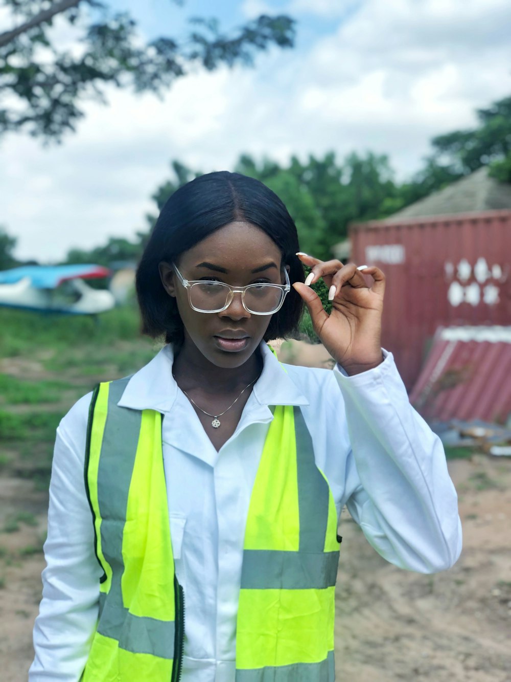 a woman wearing a safety vest and glasses