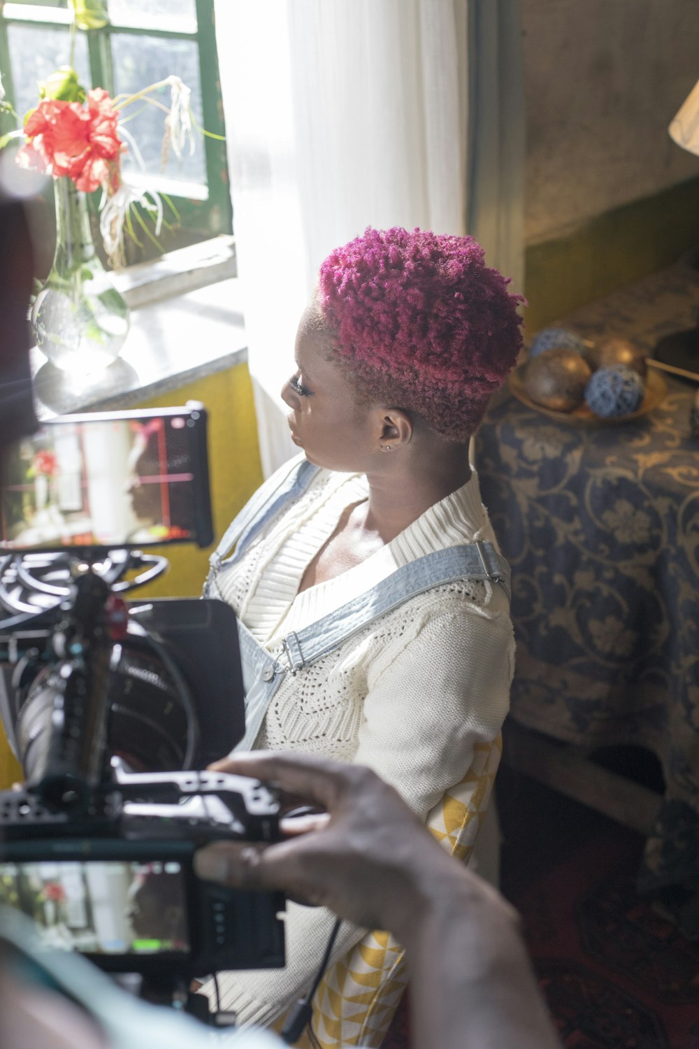 a woman sitting in a chair with a camera