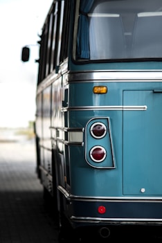 a blue bus parked on the side of the road