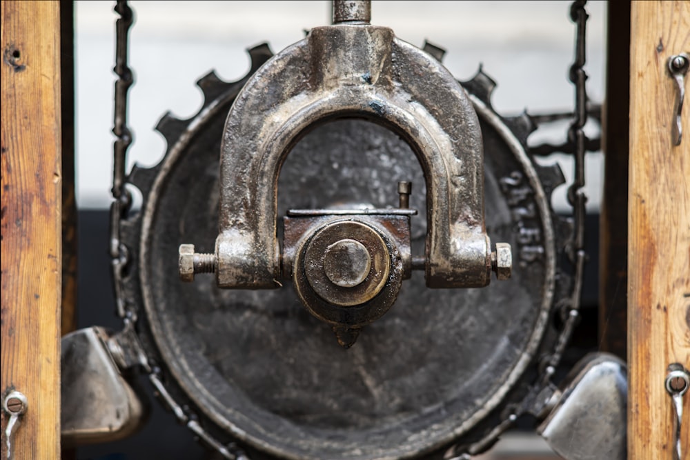 a close up of a metal object with a wooden frame