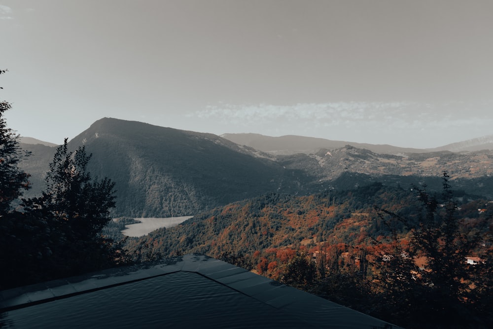 a view of a mountain range with a lake in the foreground