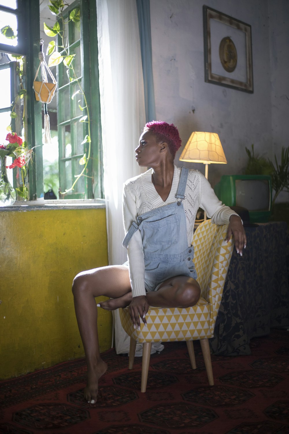 a woman sitting in a chair in a room