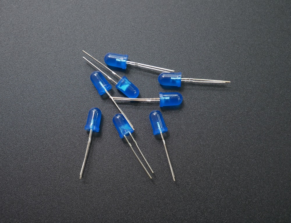 a group of blue capacitors sitting on top of a table