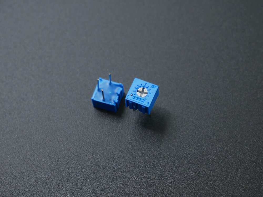 a couple of small blue objects sitting on top of a table