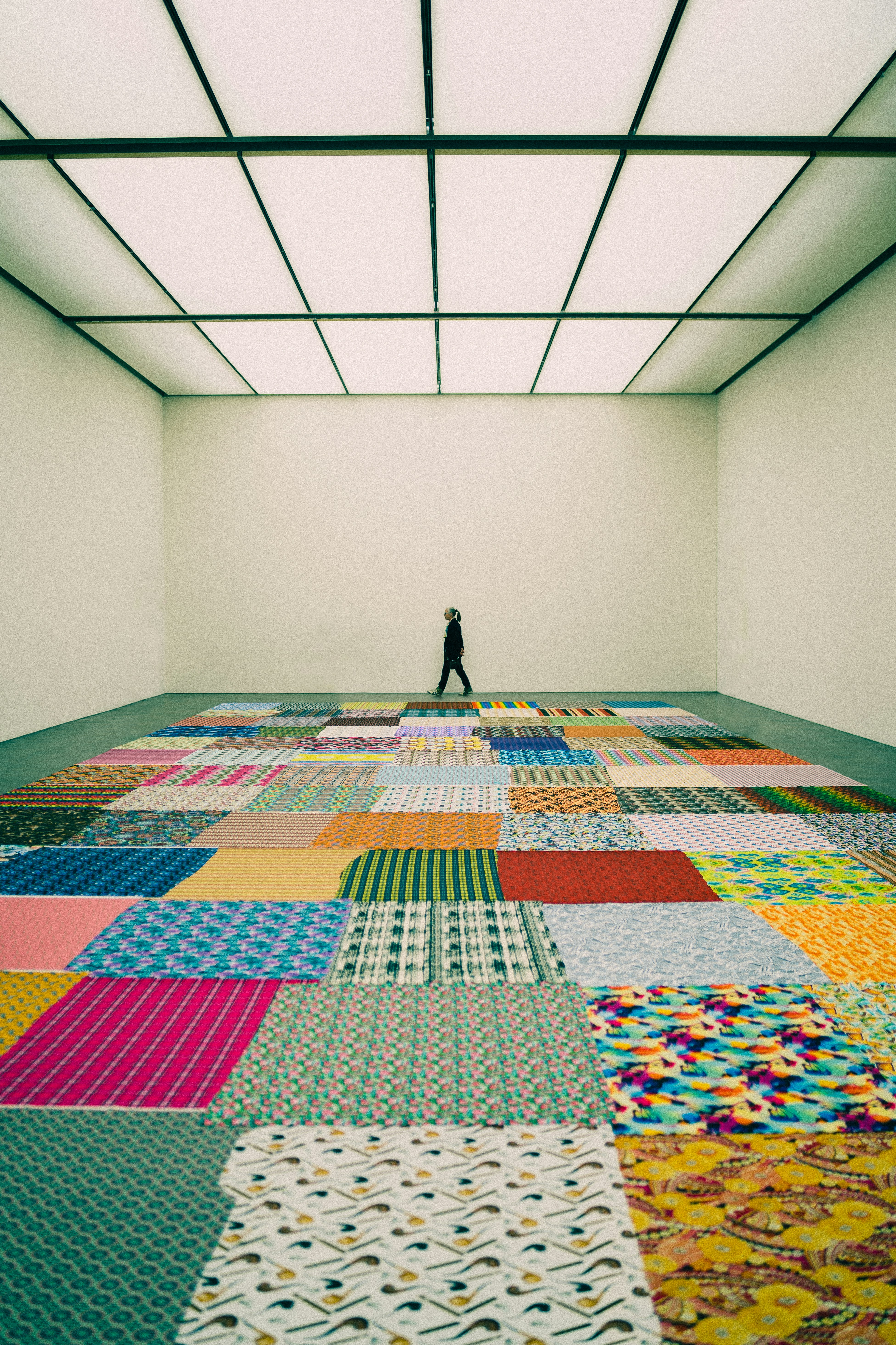 a person standing on a patchwork floor in a room