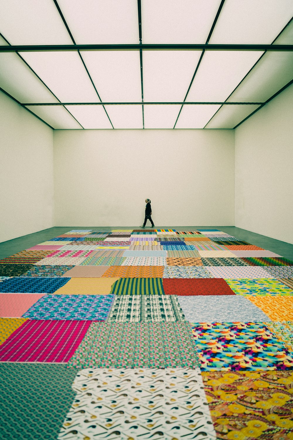 a person standing on a patchwork floor in a room