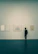 Close-up of a minimalist gallery corner with warm-colored frames.