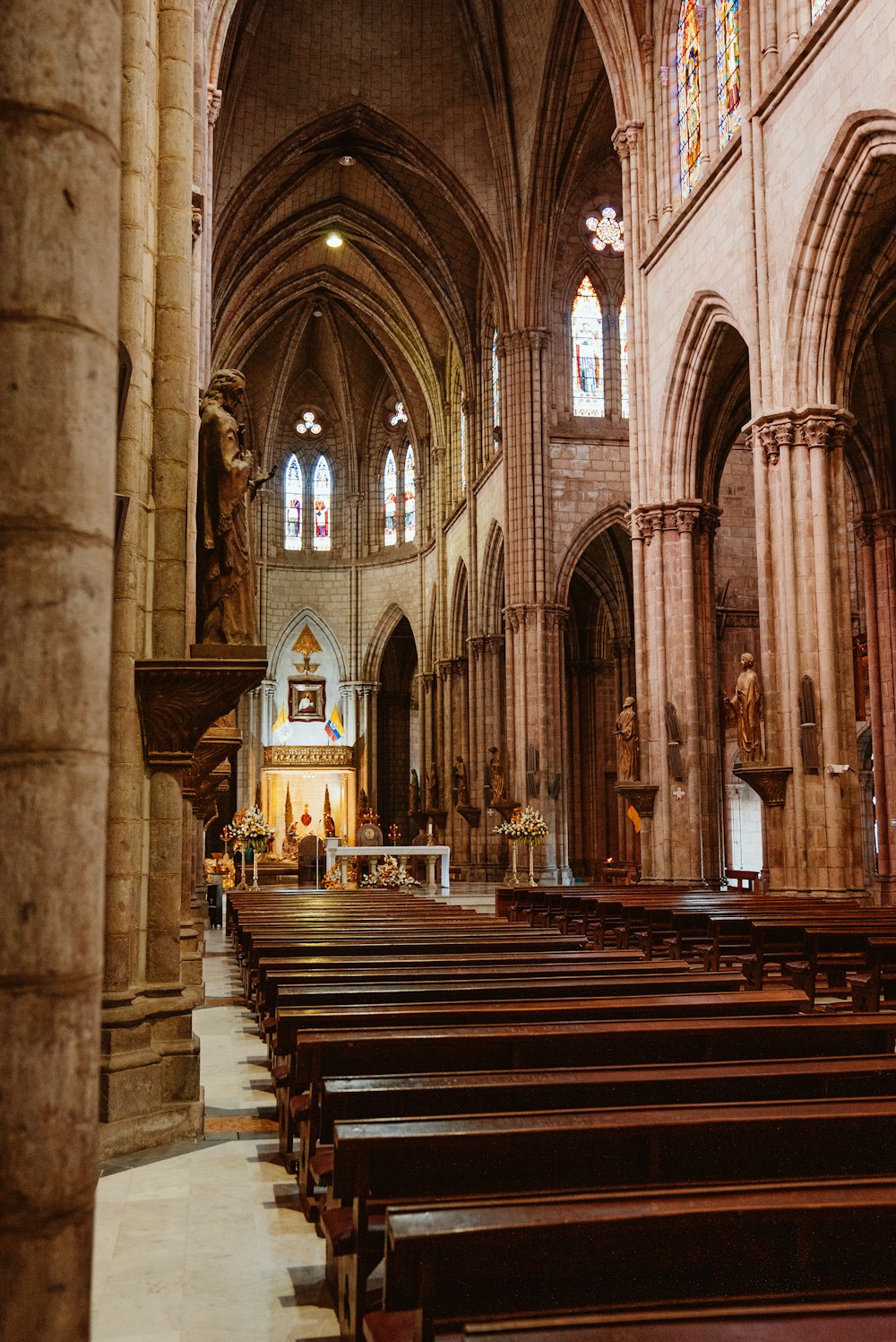 a church with pews and stained glass windows