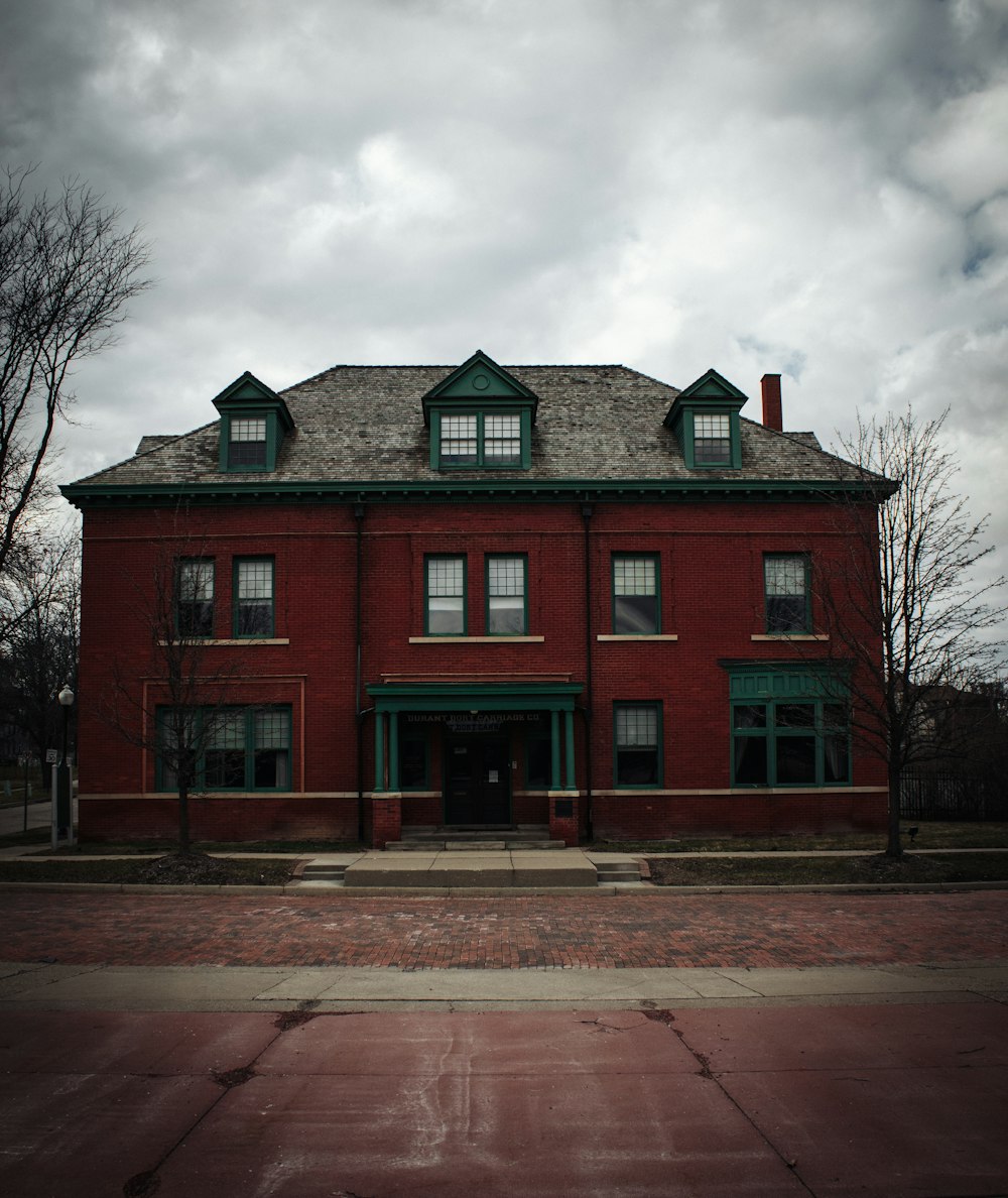 a large red brick building with a green roof