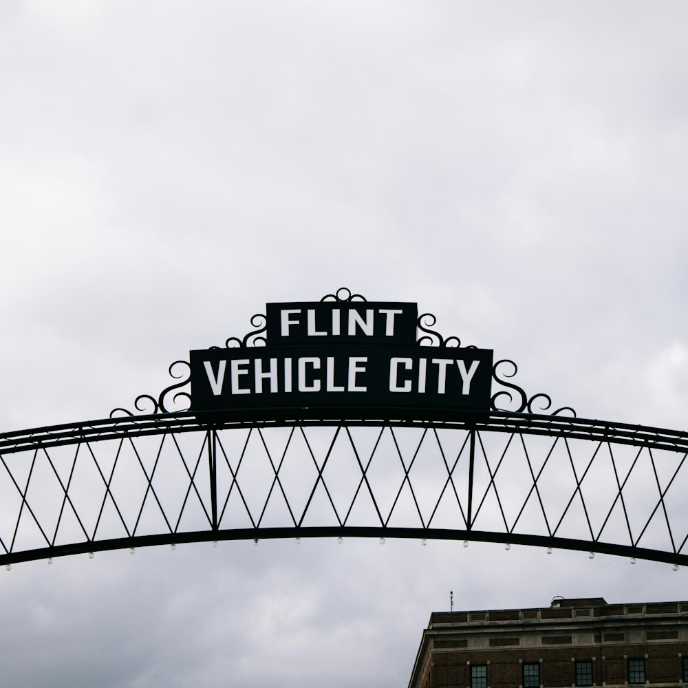 a black and white sign that reads flint vehicle city