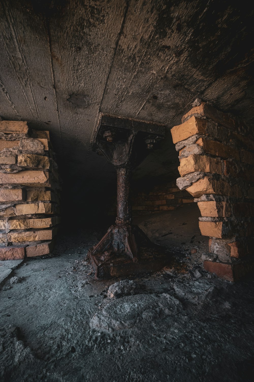 an old brick building with a tree stump sticking out of it