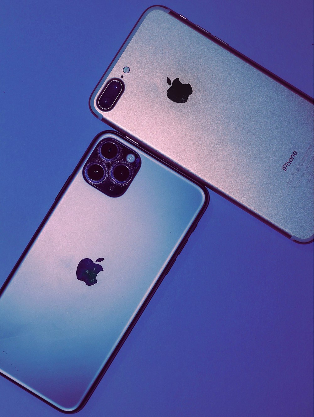 two iphones side by side on a blue background