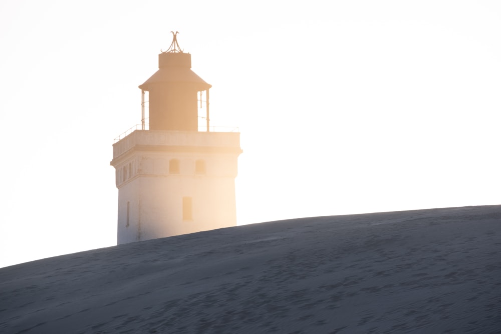 a light house on top of a snowy hill