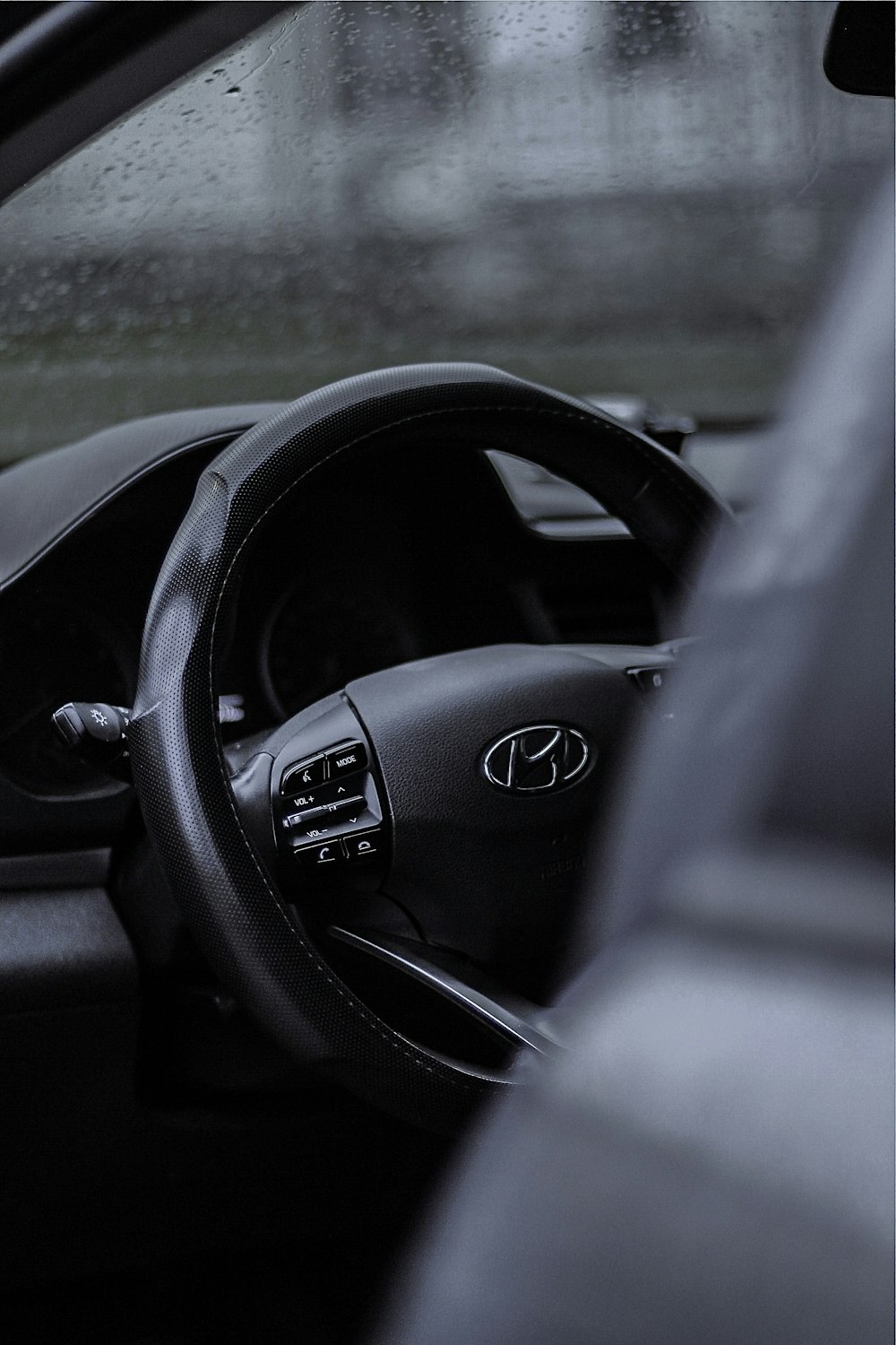 a steering wheel of a car in the rain