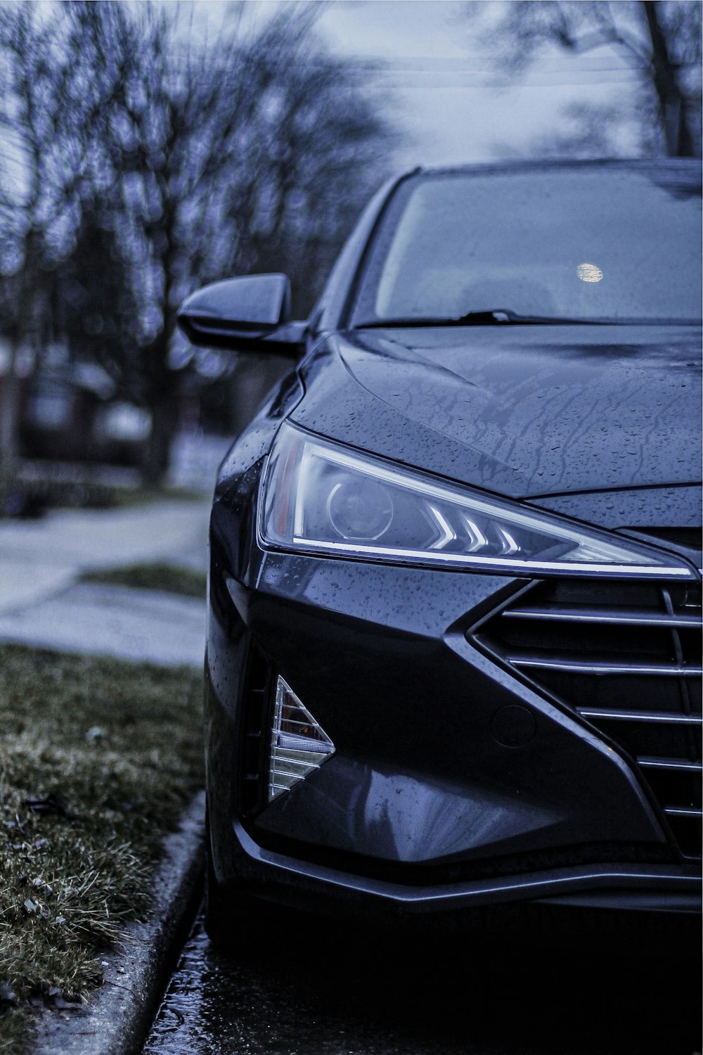 a black car parked on the side of the road