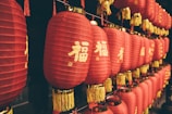 many red lanterns are hanging on a wall