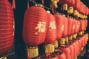 many red lanterns are hanging on a wall