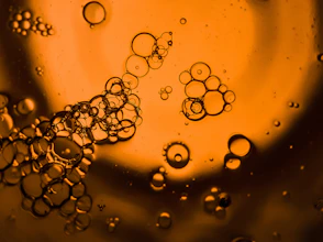 a close up of water bubbles on a yellow background