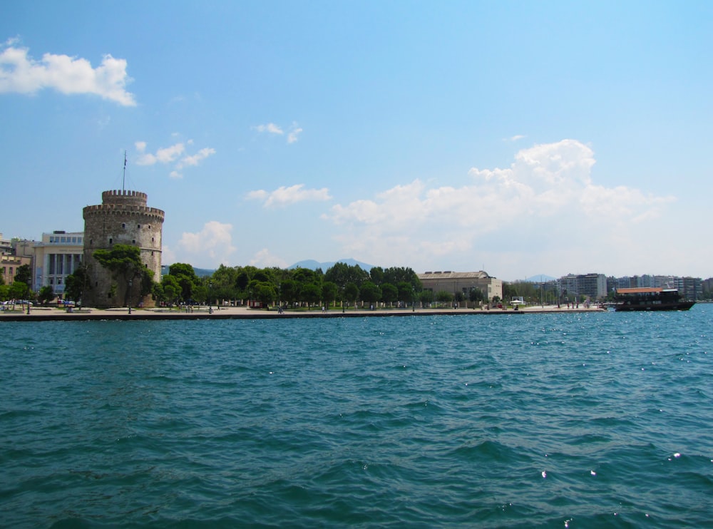 a large body of water with a castle in the background