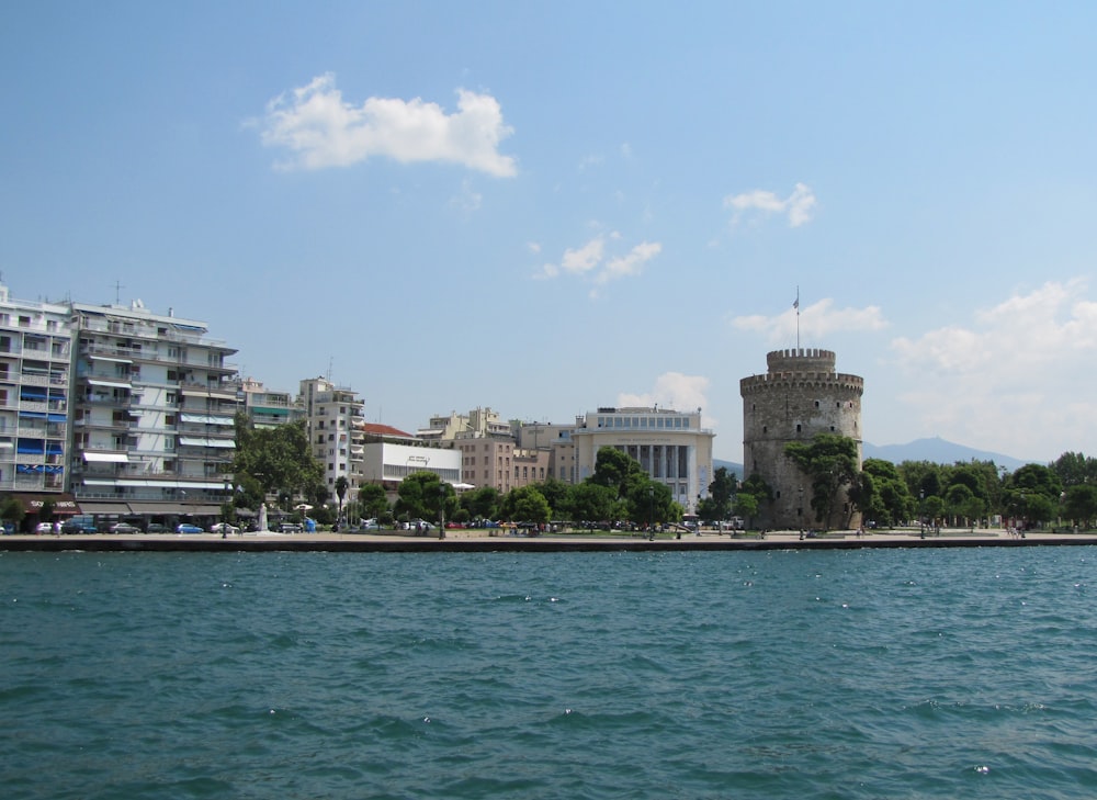 a body of water with buildings in the background