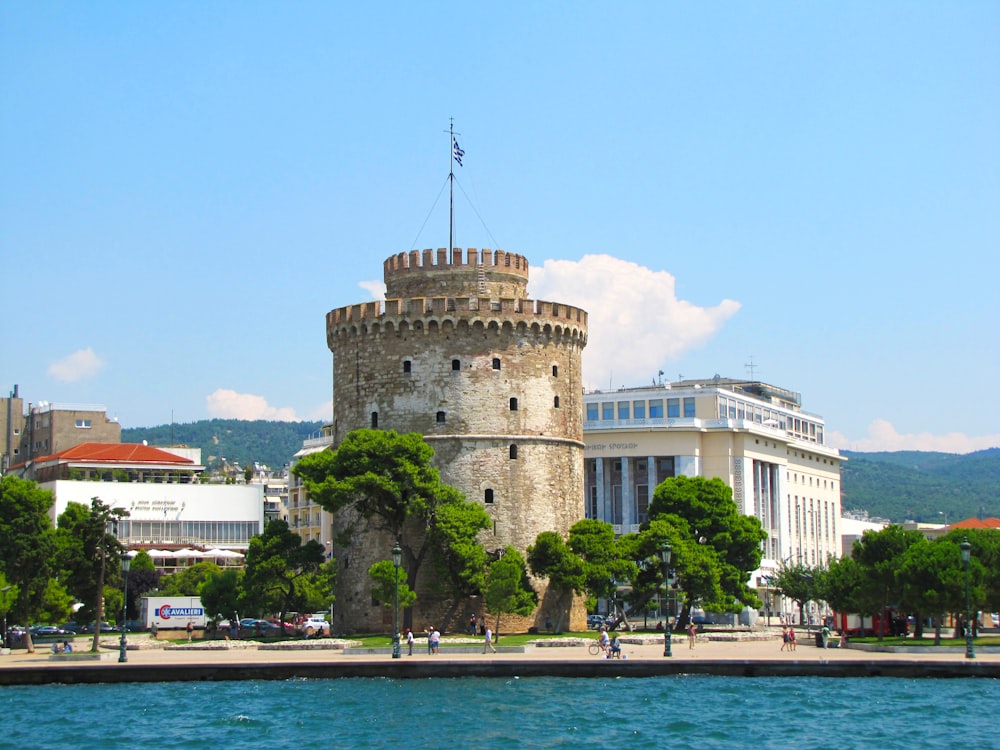 a large castle sitting on top of a lush green hillside