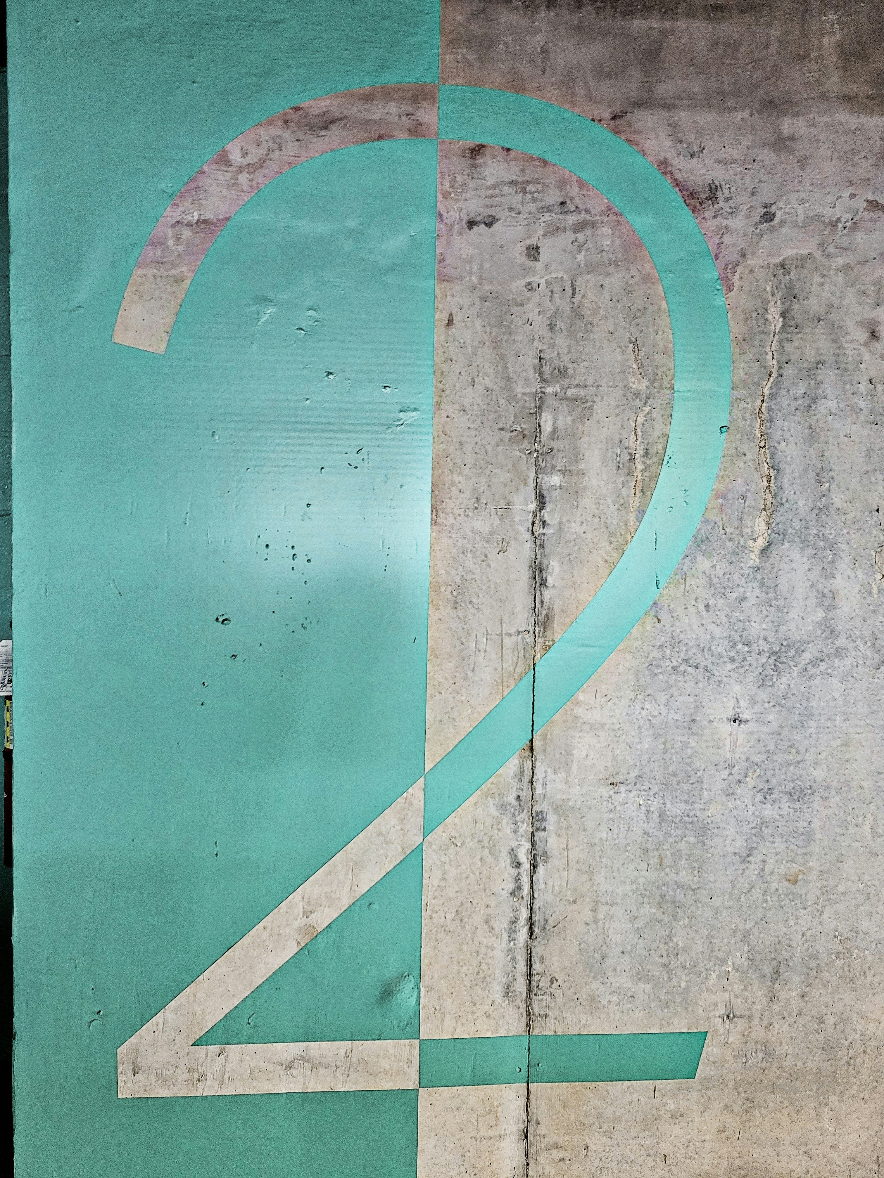 a green and white wall with a clock on it