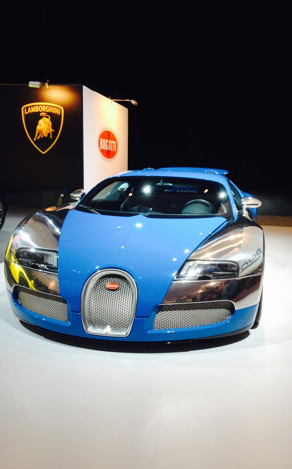 a blue bugatti on display at a car show