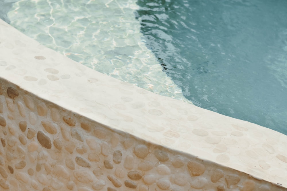 a close up of a pool with a water feature