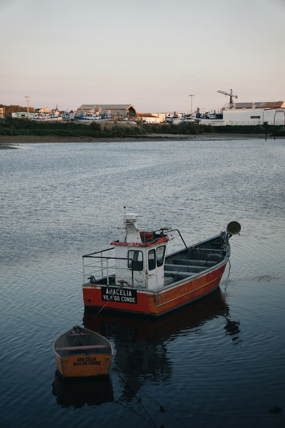 a small boat floating on top of a body of water