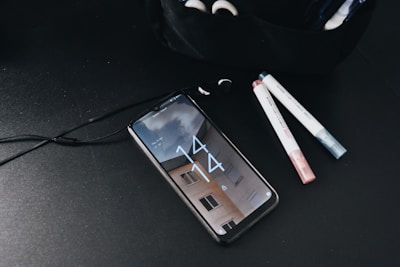 a cell phone sitting on top of a table next to a bag