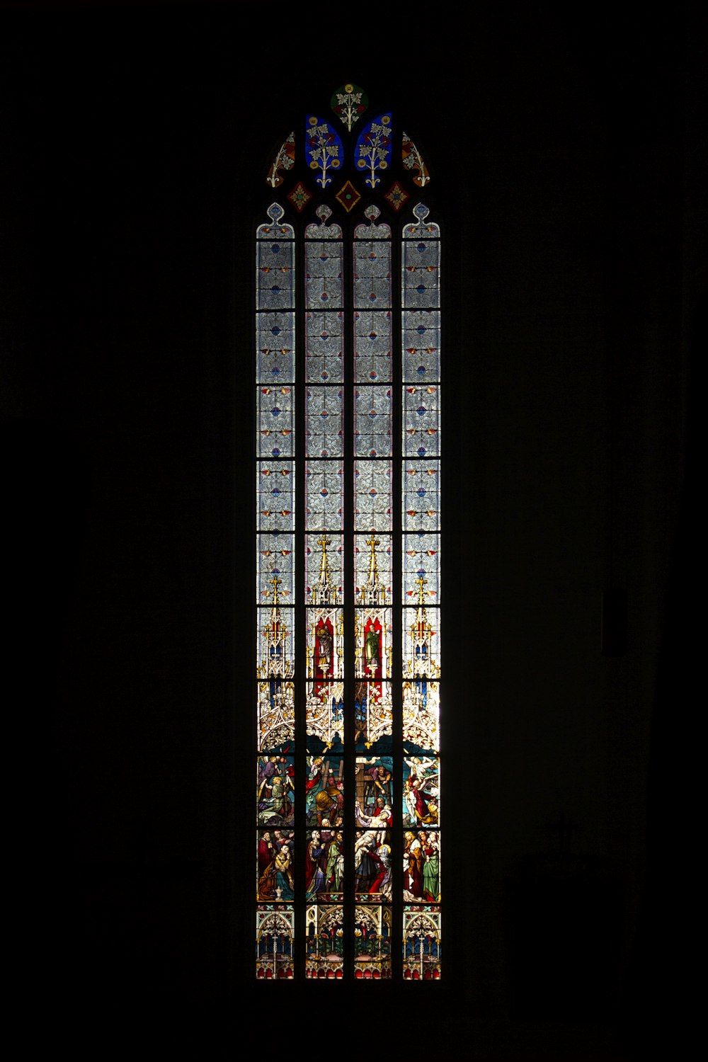 a stained glass window in a dark room