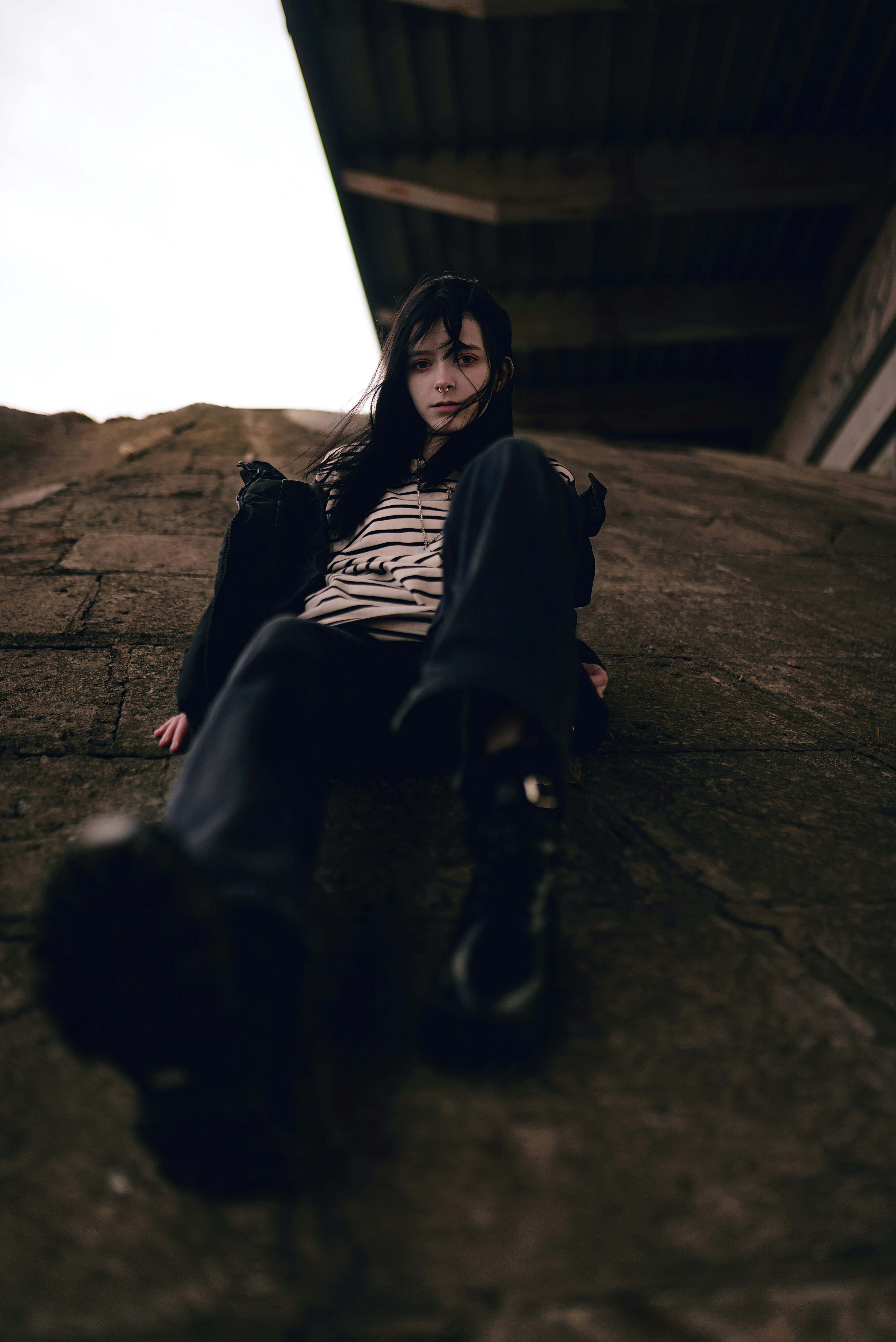 a woman sitting on the ground with her legs crossed