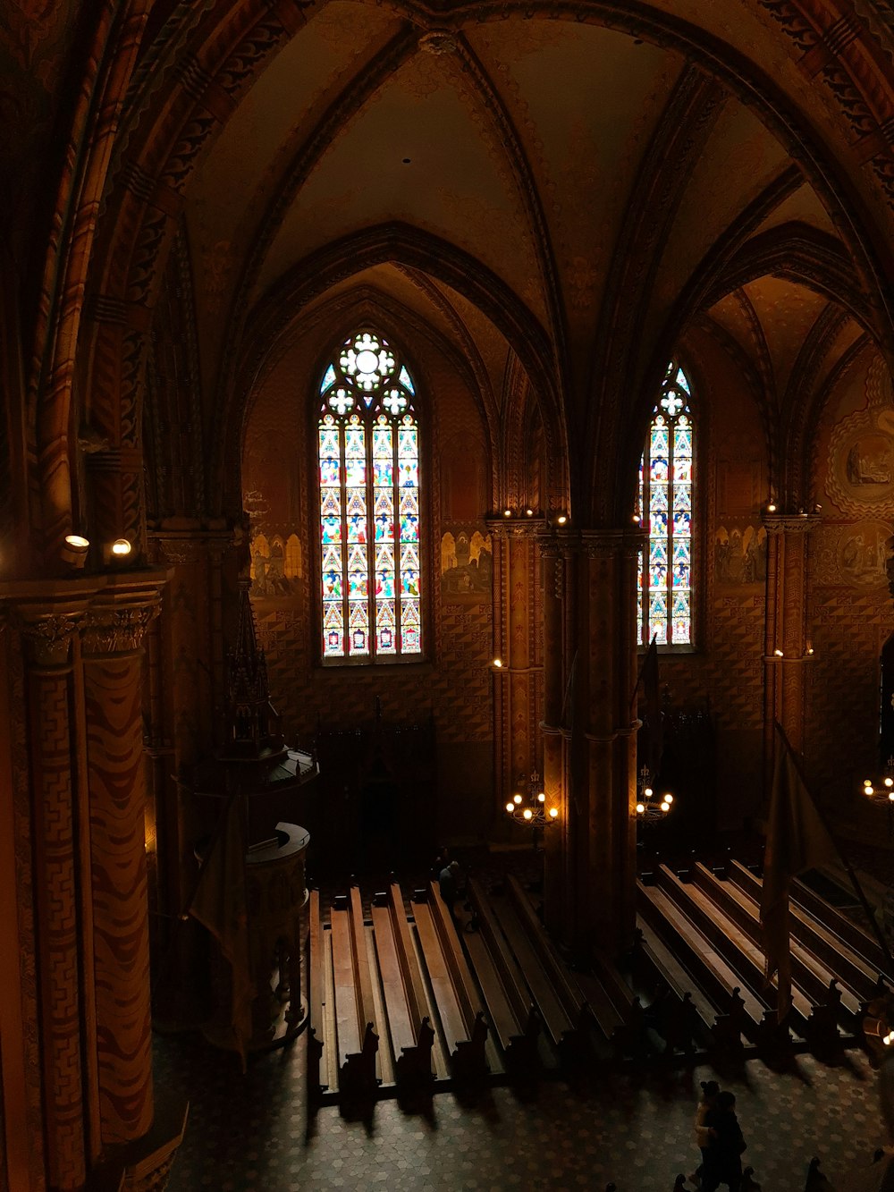 a church with stained glass windows and pews