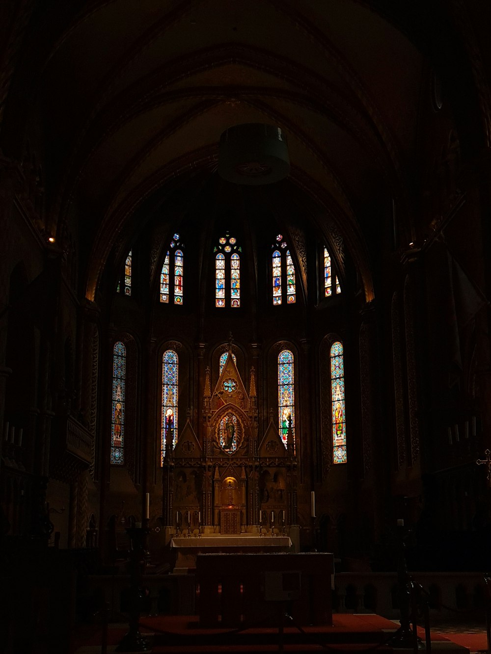 a church with stained glass windows and pews