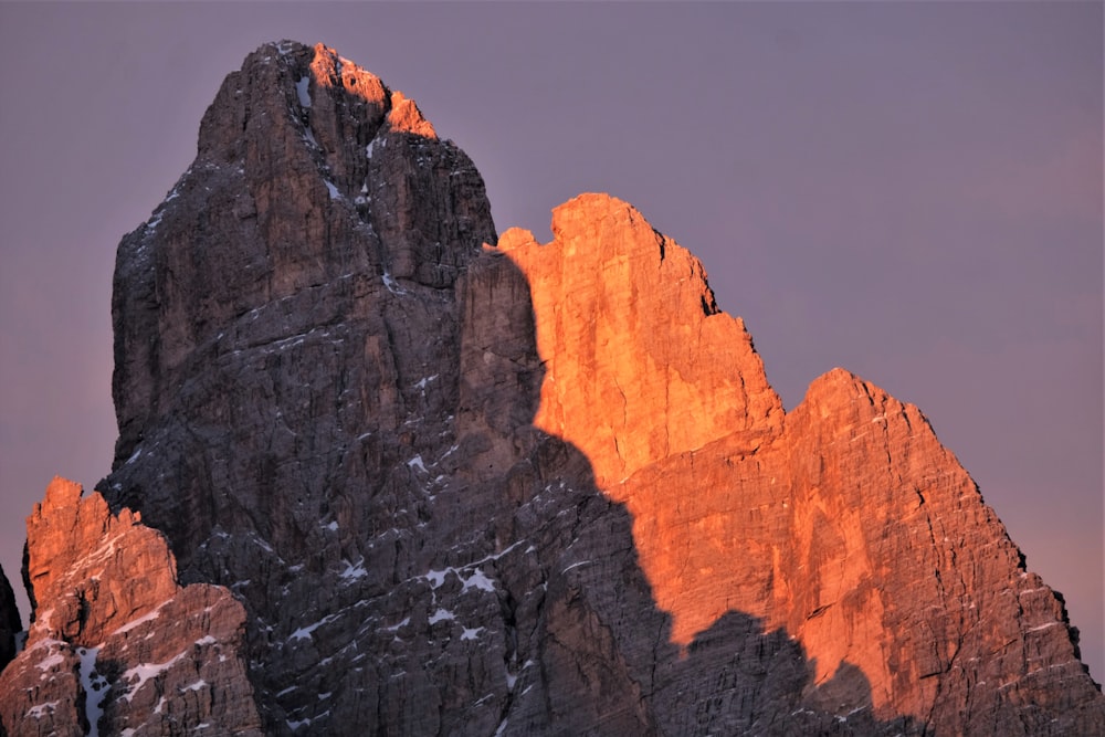 a very tall mountain with snow on it's sides