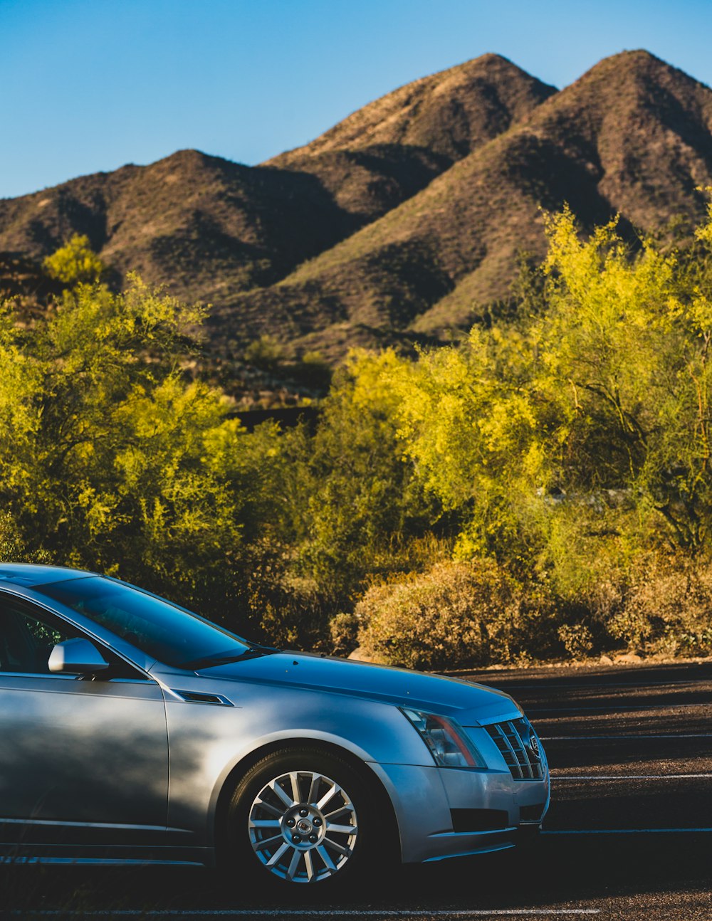 a silver car parked on the side of the road