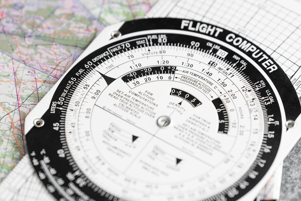 a close up of a compass on a map