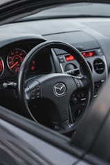 the dashboard of a car with a red light on