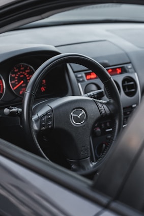 the dashboard of a car with a red light on