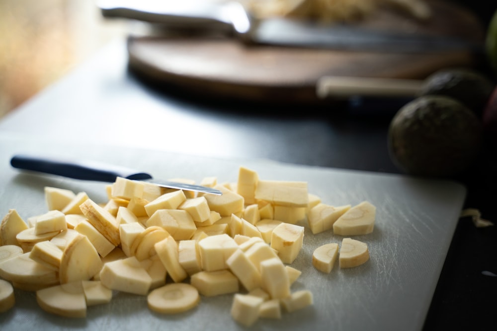 a cutting board with chopped up cheese on it