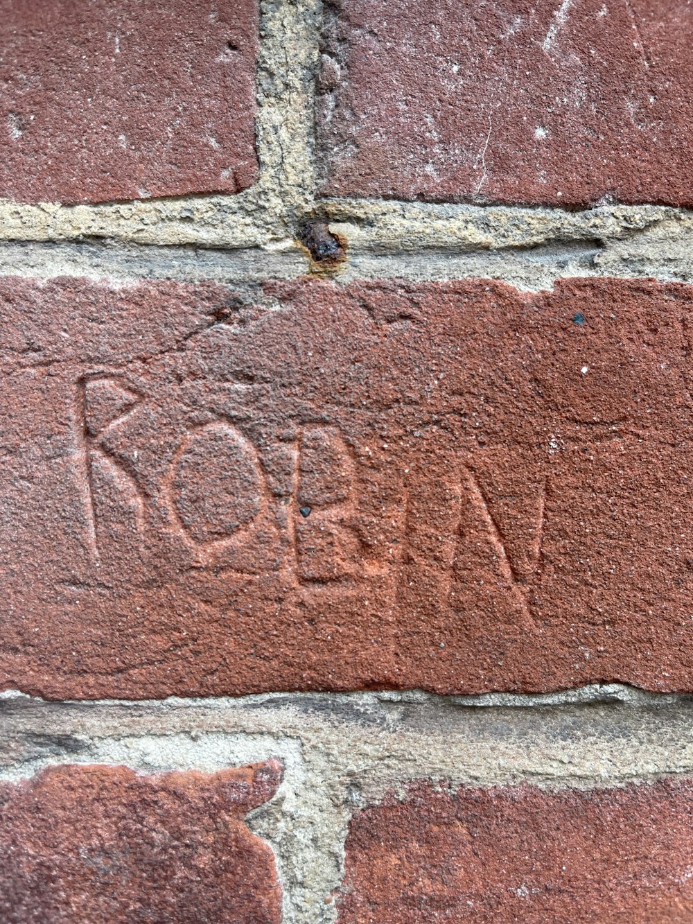 a brick wall with a word written on it