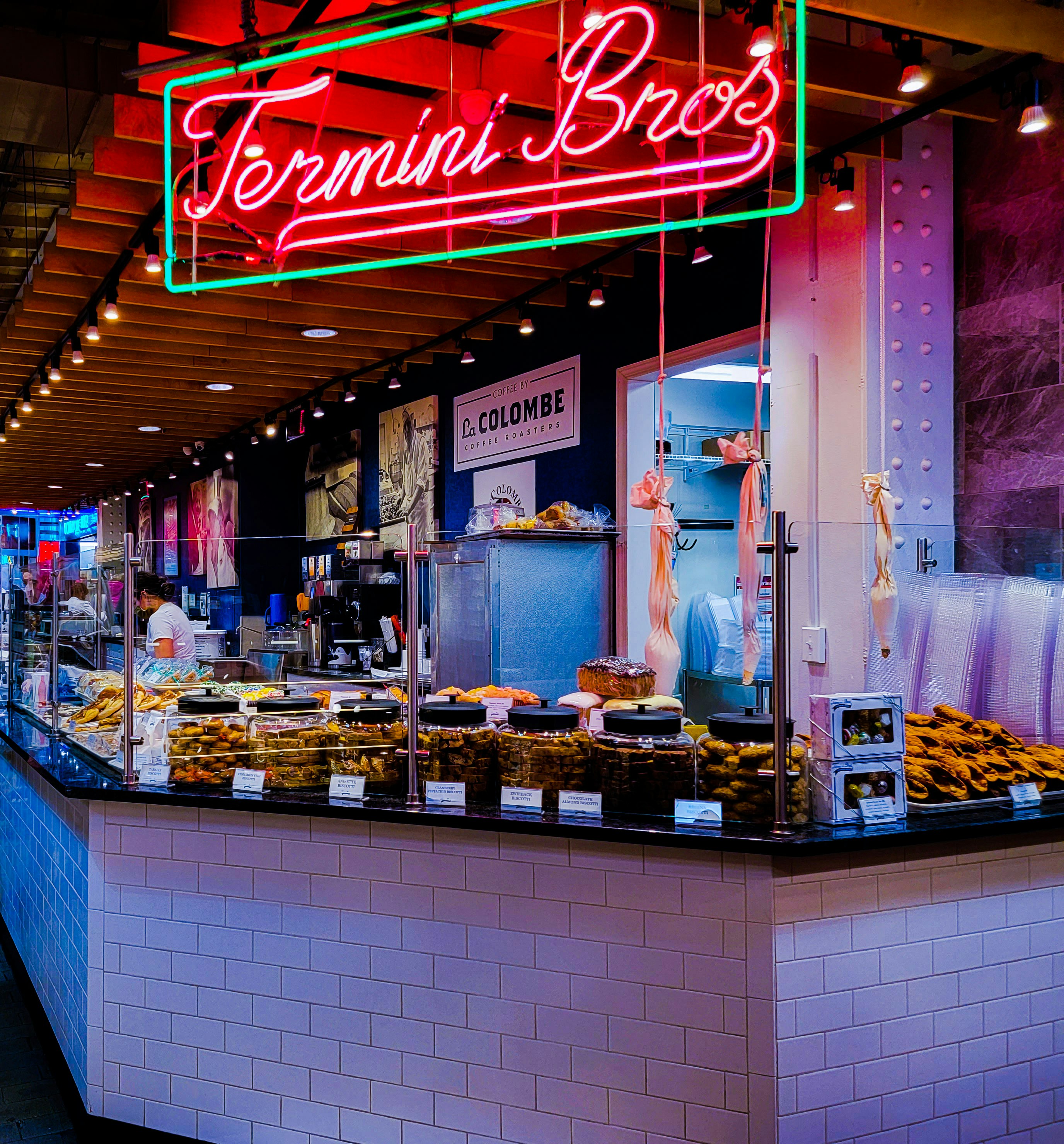 a food stand with a neon sign above it