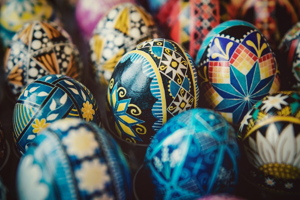 a pile of colorfully painted eggs sitting on top of each other