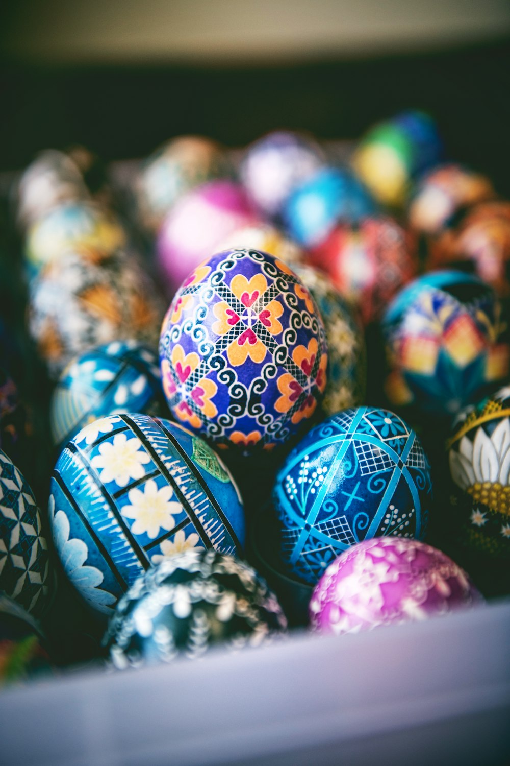 a bunch of colorful easter eggs in a box