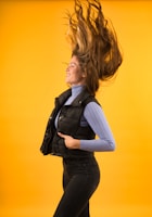 a woman with her hair flying in the air