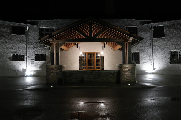 Night view of a townhouse with well-lit facade and welcoming entrance