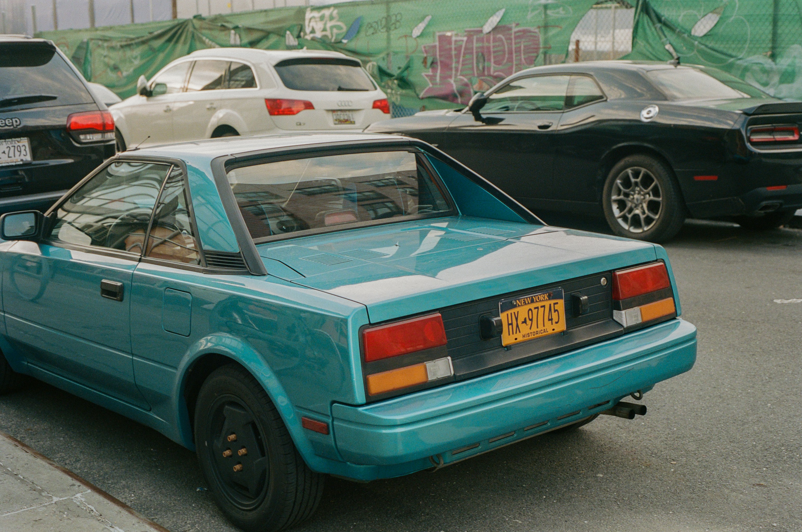 a blue car parked on the side of the road