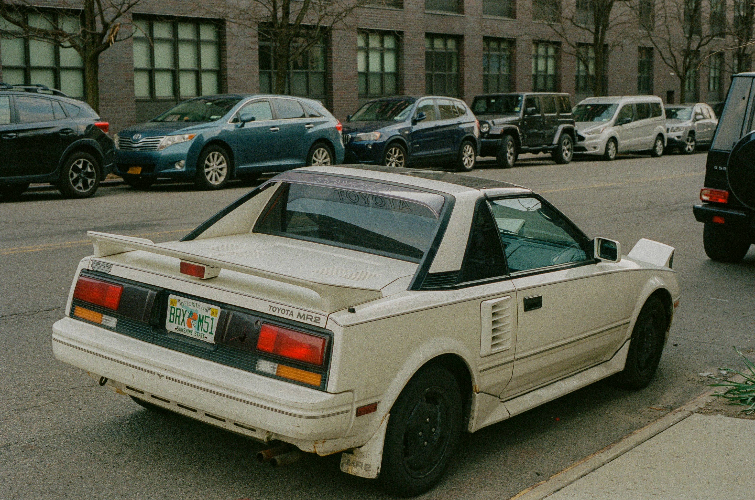 a white car parked on the side of the road